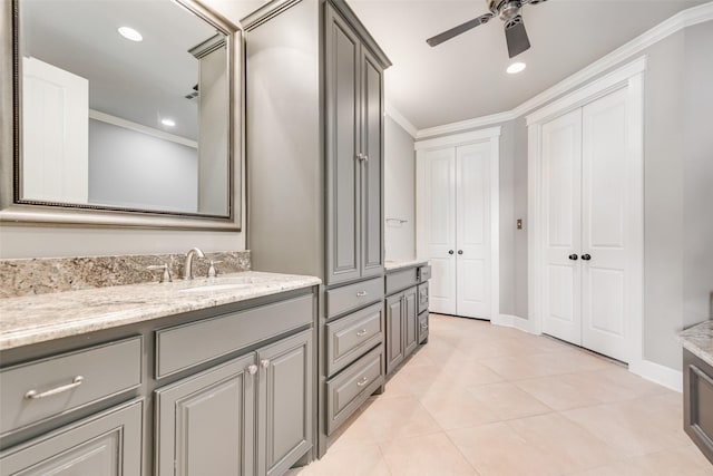 bathroom featuring crown molding, tile patterned flooring, ceiling fan, and vanity