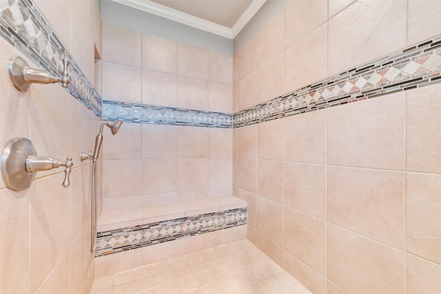 bathroom featuring ornamental molding and a tile shower