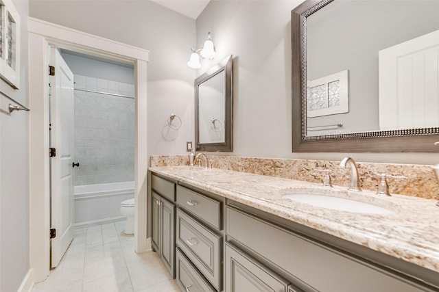 full bathroom featuring vanity, toilet, tile patterned floors, and tiled shower / bath combo