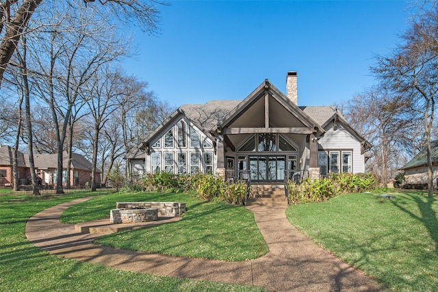 rear view of property featuring a lawn and french doors