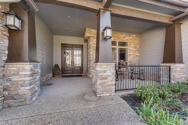 view of exterior entry with covered porch