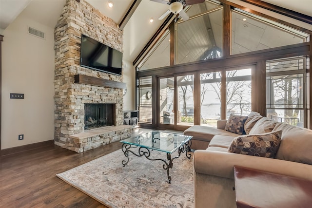 living room with a fireplace, wood-type flooring, beamed ceiling, and high vaulted ceiling