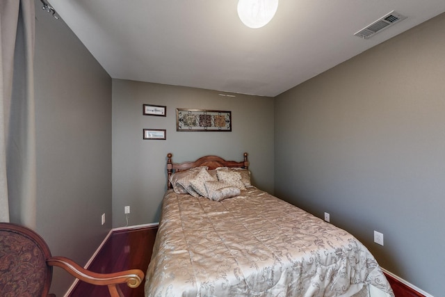 bedroom with hardwood / wood-style flooring