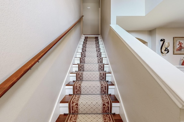 staircase featuring wood-type flooring