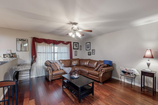 living room featuring dark hardwood / wood-style floors and ceiling fan