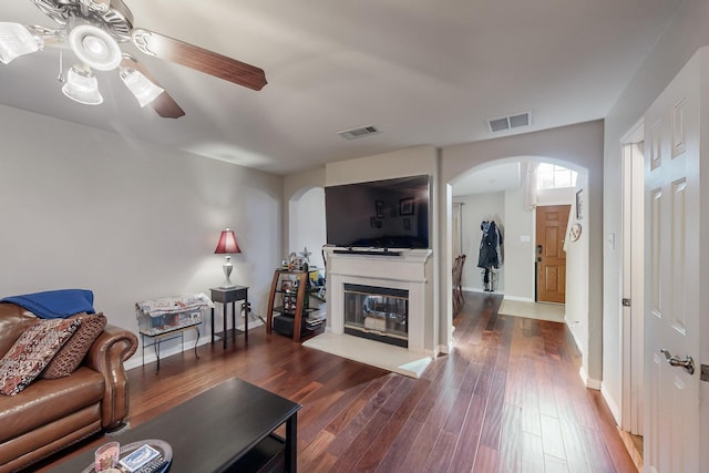 living room featuring dark hardwood / wood-style floors and ceiling fan