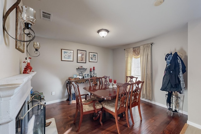 dining space with dark hardwood / wood-style flooring