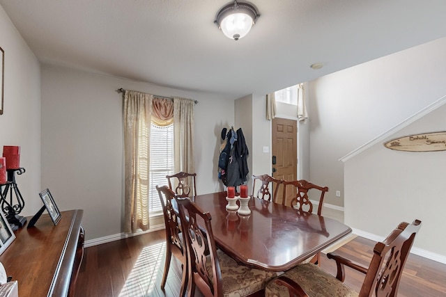 dining space with dark hardwood / wood-style flooring