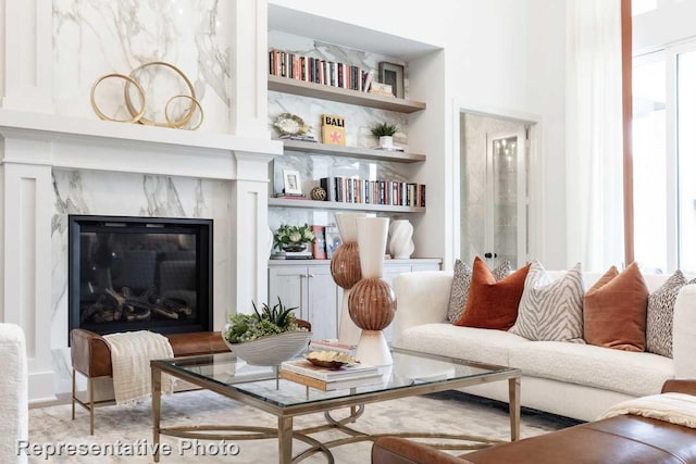 interior space with a high end fireplace and built in features