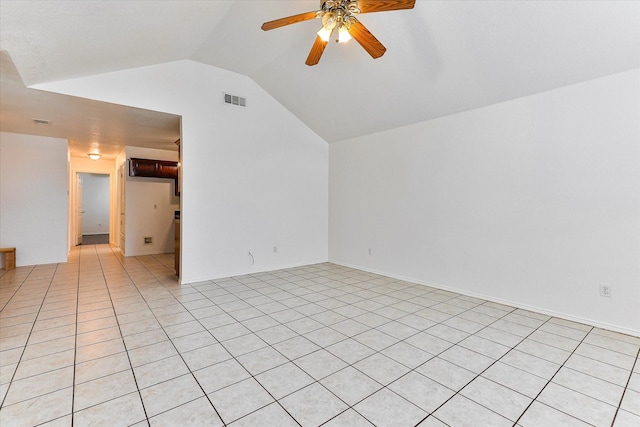 unfurnished room featuring ceiling fan, lofted ceiling, and light tile patterned flooring