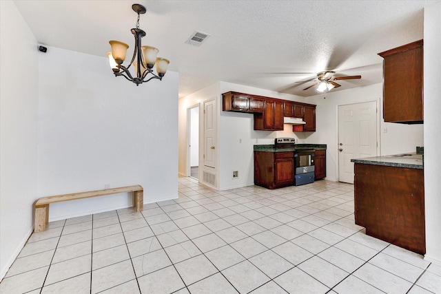 kitchen with a textured ceiling, stainless steel electric range oven, hanging light fixtures, light tile patterned floors, and ceiling fan with notable chandelier