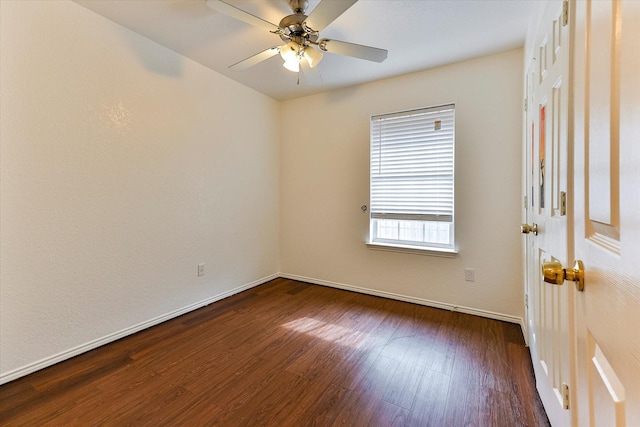 unfurnished room with ceiling fan and dark wood-type flooring