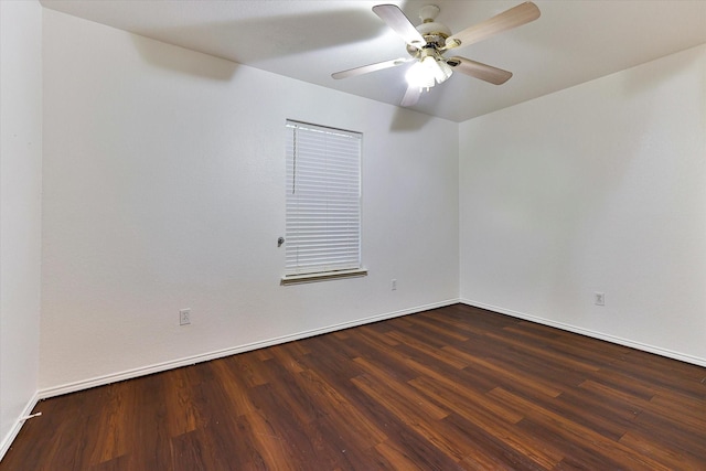 spare room with ceiling fan and dark hardwood / wood-style floors