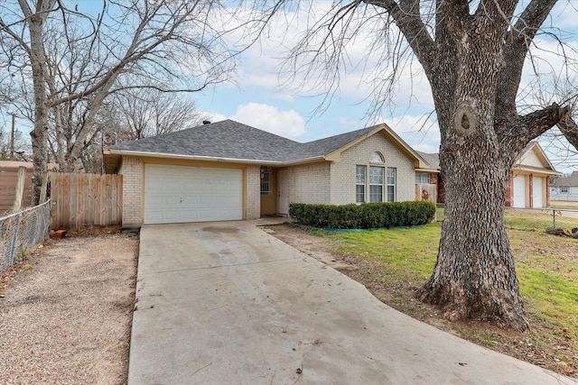 ranch-style home featuring a garage and a front lawn