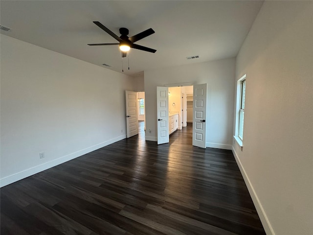 unfurnished bedroom with dark wood-type flooring and ceiling fan