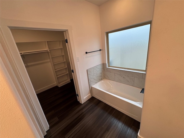 bathroom featuring hardwood / wood-style flooring and a bath