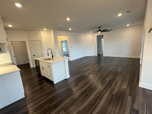 kitchen with dishwasher, a kitchen island with sink, sink, and white cabinets