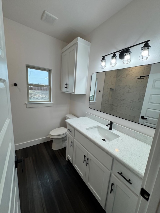 bathroom featuring wood-type flooring, toilet, and vanity