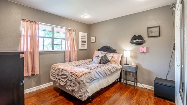 bedroom with hardwood / wood-style flooring