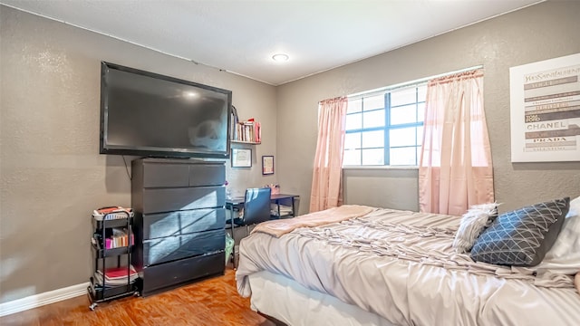 bedroom with hardwood / wood-style flooring