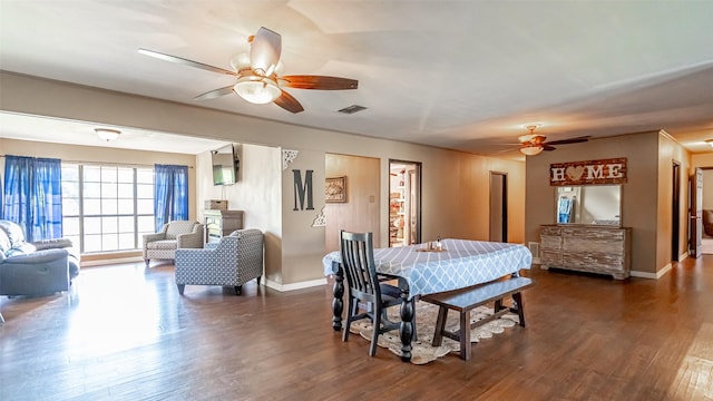 dining area featuring ceiling fan and dark wood-type flooring