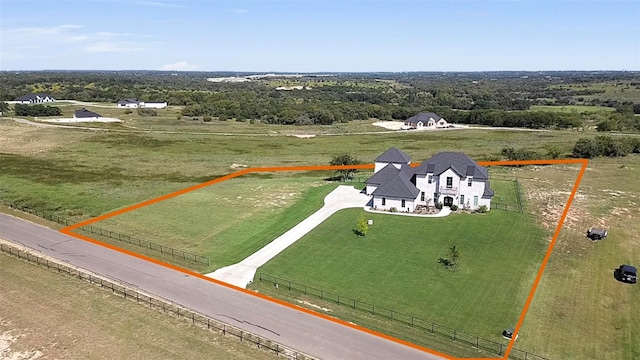 birds eye view of property with a rural view