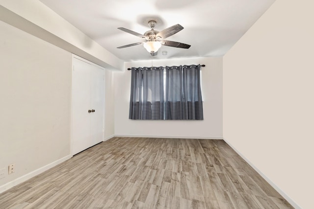 spare room featuring light hardwood / wood-style flooring and ceiling fan