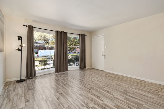 spare room featuring light hardwood / wood-style floors and a water view