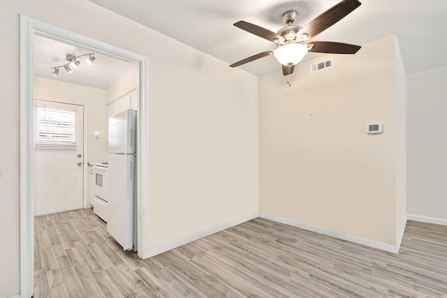 empty room featuring light wood-type flooring and ceiling fan