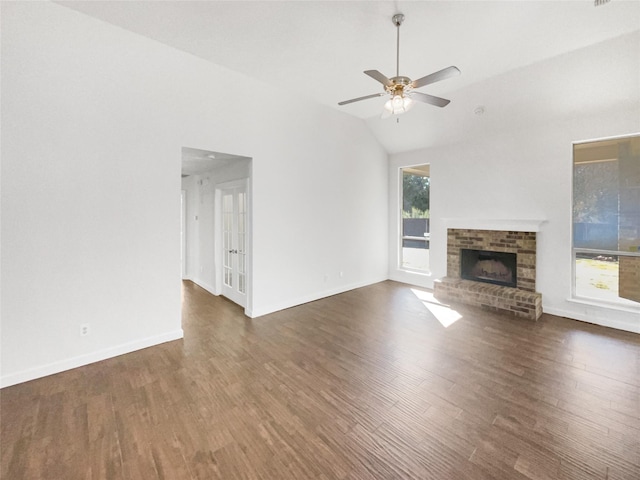 unfurnished living room featuring ceiling fan, dark wood-type flooring, lofted ceiling, and a fireplace