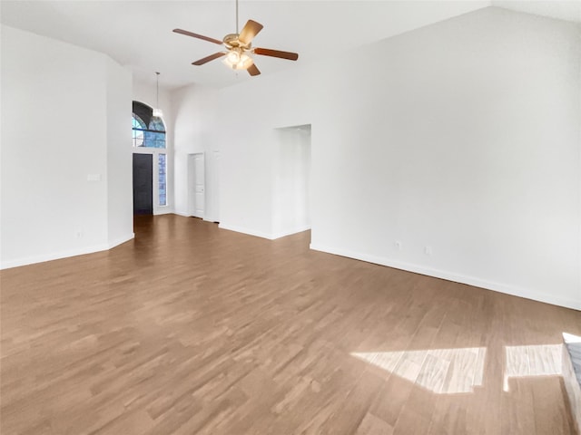 unfurnished living room featuring lofted ceiling, hardwood / wood-style floors, and ceiling fan