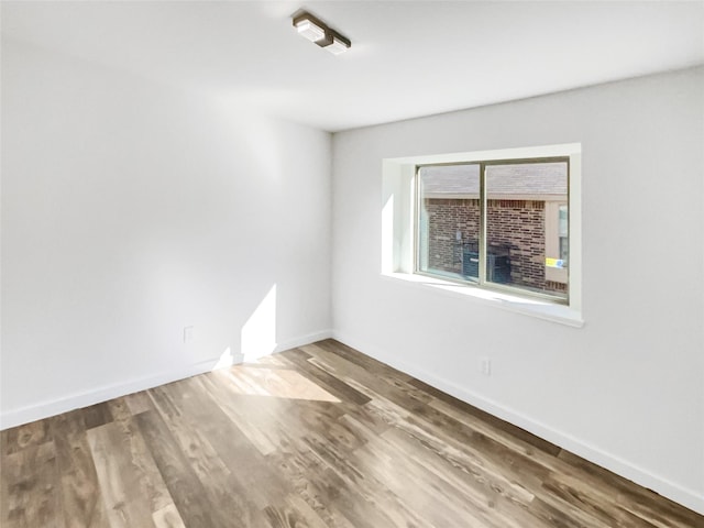 unfurnished room featuring hardwood / wood-style flooring