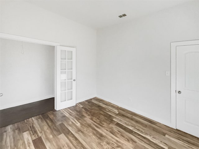 spare room featuring dark hardwood / wood-style floors