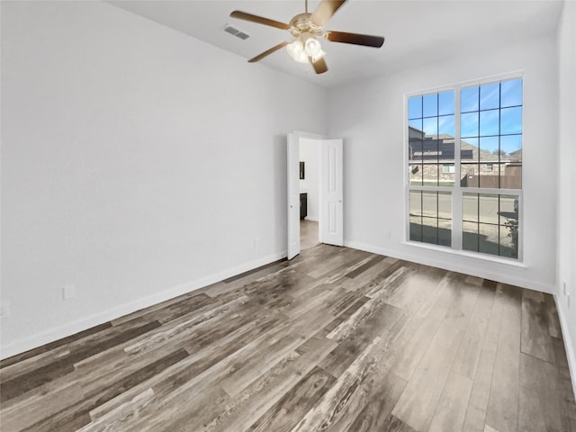 unfurnished room with hardwood / wood-style flooring and ceiling fan