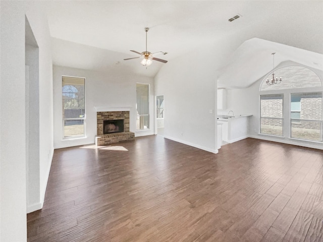 unfurnished living room featuring a wealth of natural light, dark hardwood / wood-style flooring, and lofted ceiling