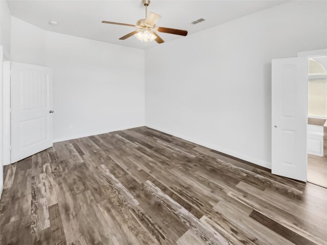 spare room featuring ceiling fan and dark wood-type flooring