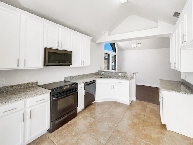 kitchen with kitchen peninsula, vaulted ceiling, sink, white cabinetry, and black appliances