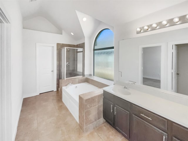 bathroom with vanity, vaulted ceiling, shower with separate bathtub, and tile patterned flooring