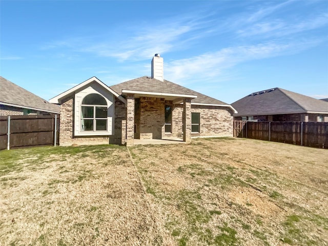 rear view of house featuring a lawn