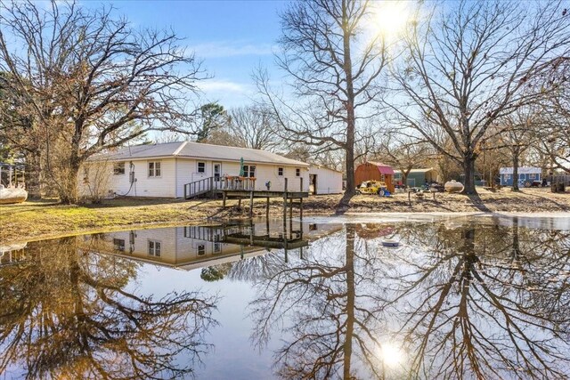 back of property featuring a water view