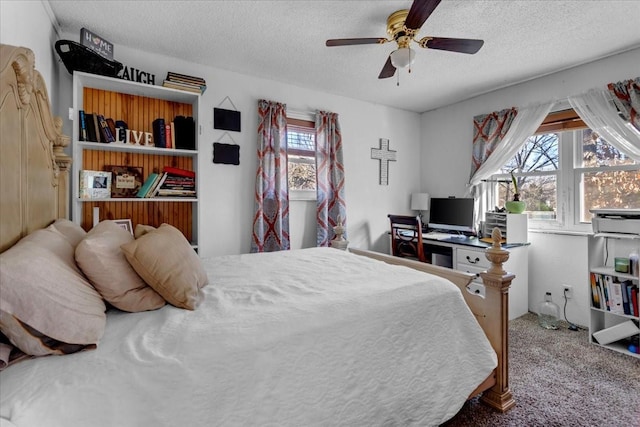 carpeted bedroom with a textured ceiling and ceiling fan