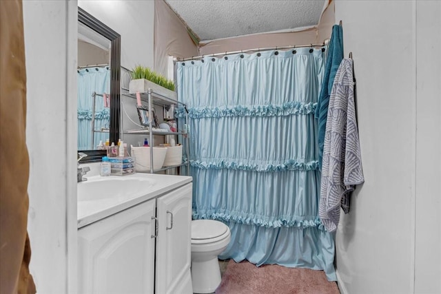 bathroom with toilet, a textured ceiling, and vanity