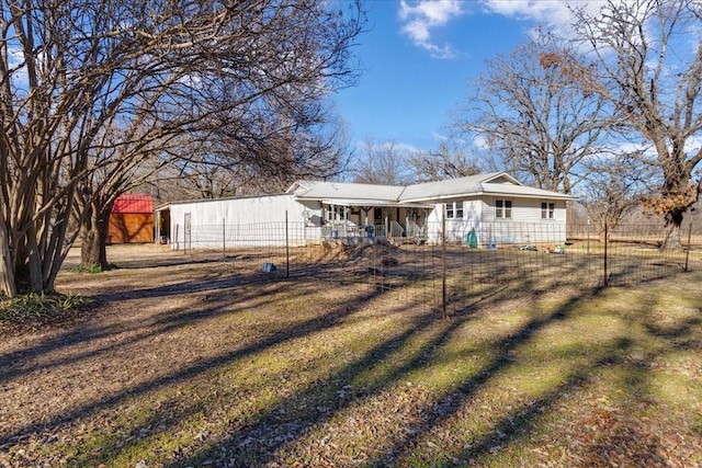 rear view of property with a yard