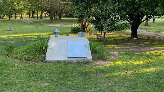 view of storm shelter with a yard