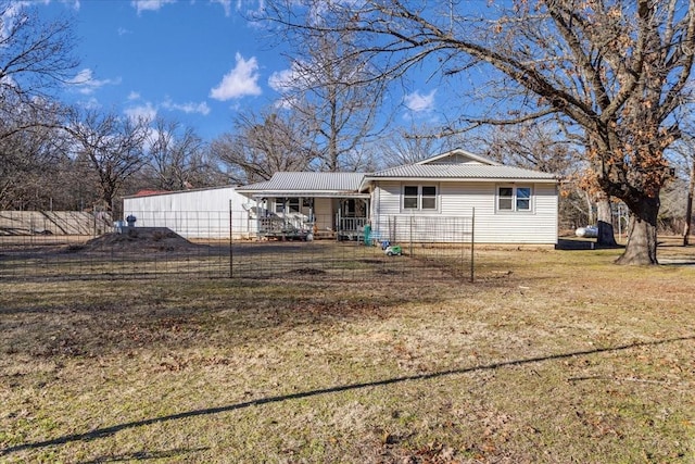 rear view of property with a lawn