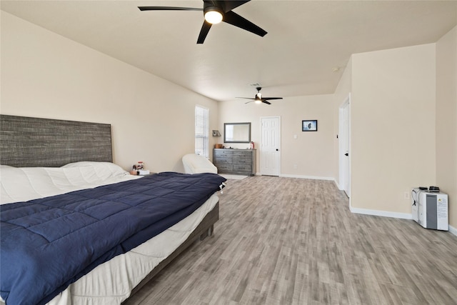 bedroom with hardwood / wood-style floors and ceiling fan