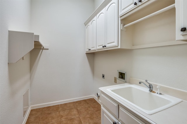 laundry area featuring sink, hookup for a washing machine, electric dryer hookup, and cabinets