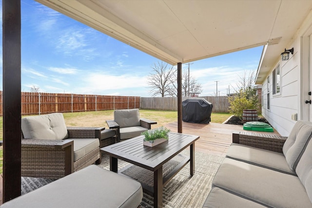 view of patio with area for grilling, a wooden deck, and an outdoor hangout area