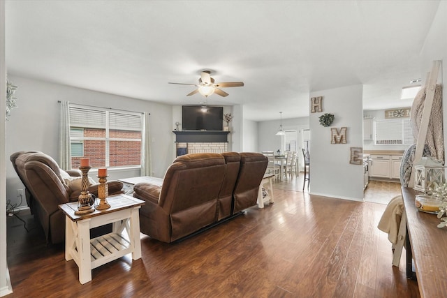 living room featuring ceiling fan and dark hardwood / wood-style flooring