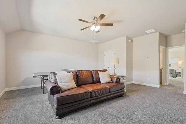 carpeted living room with vaulted ceiling, baseboards, visible vents, and ceiling fan